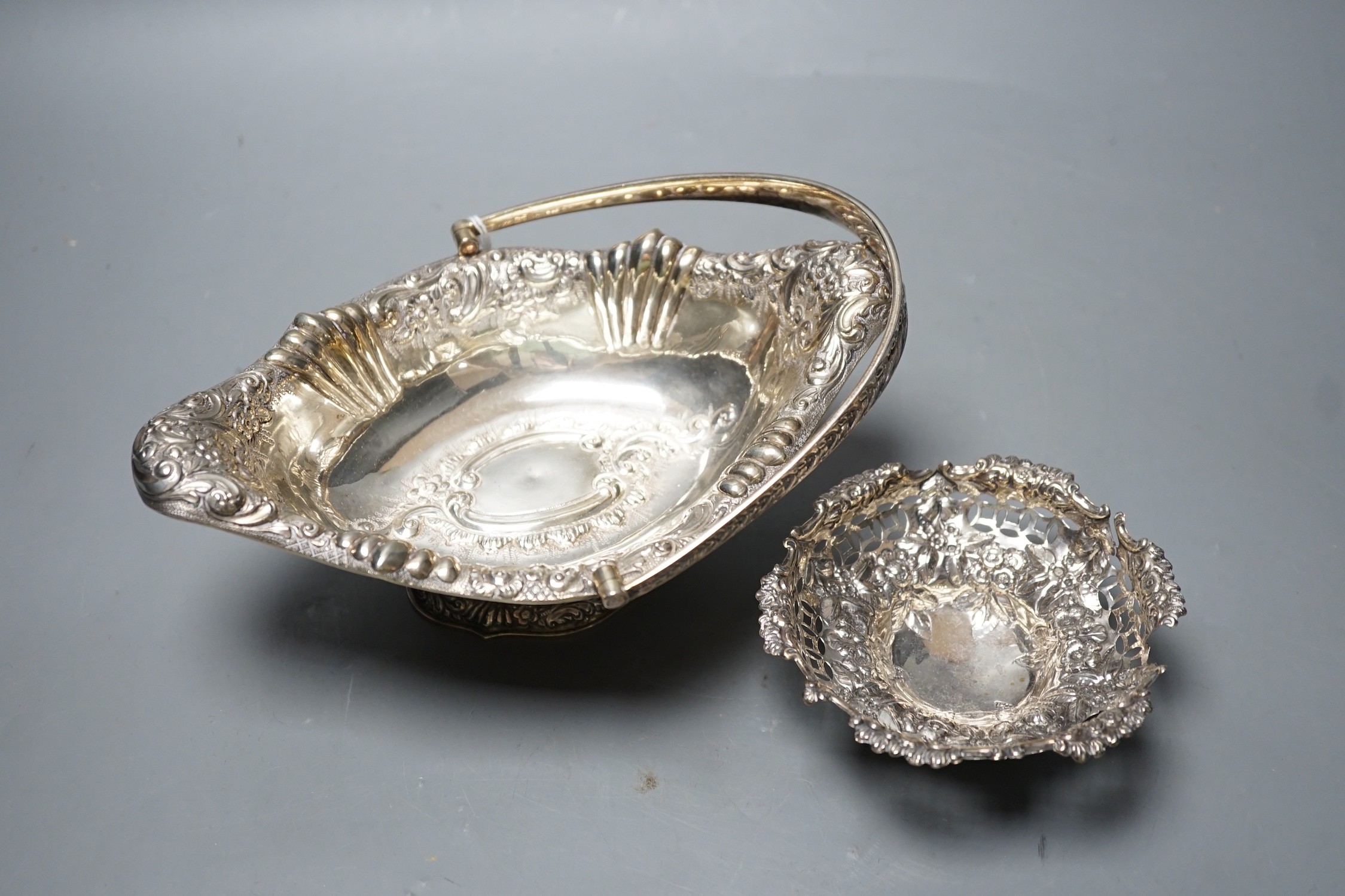A late Victorian silver oval embossed bon bon basket , Chester, 1893, 21.4cm,and a small bon bon basket, the latter (a.f.), 11oz.